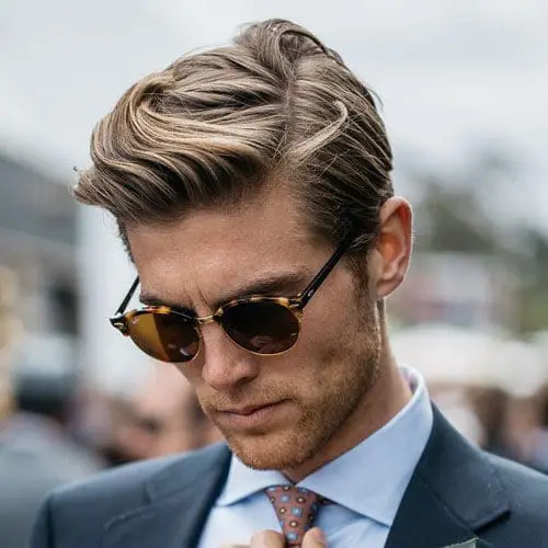 Slicked-back waves wavy side part haircut