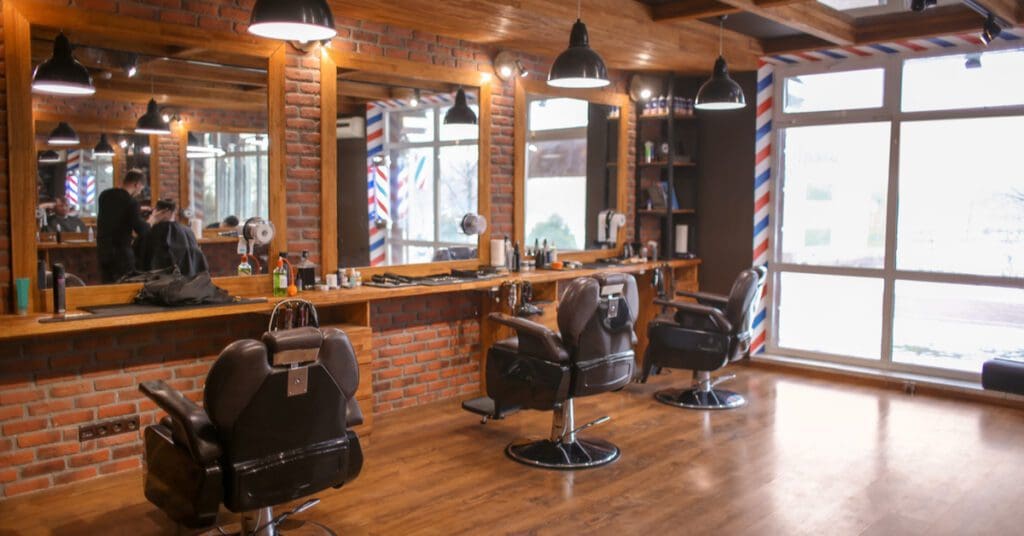 a barbershop with chairs and a brick wall
