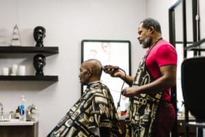 Building a loyal clientele: strategies for barbers to keep clients coming back barber shaving a mans head