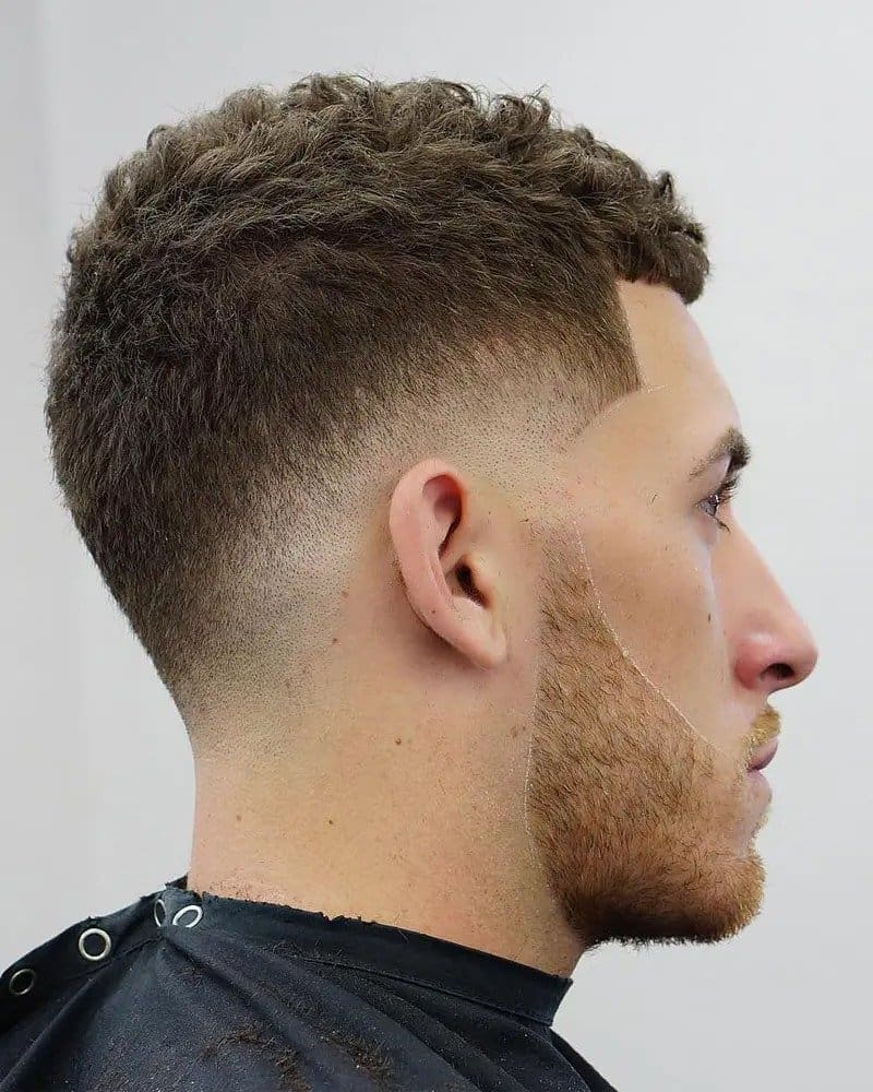a profile of a man with a bald drop fade haircut