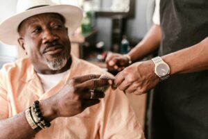 african american tipping an african american barber while sitting in a barber chair